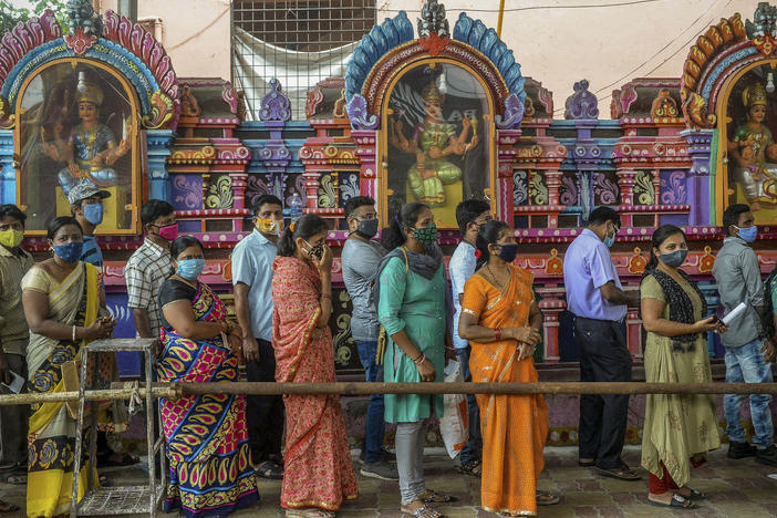 On June 25, people queued up to register for a COVID-19 vaccine at a site outside a Hindu temple in Hyderabad. Vaccinations are now being administered after a series of missteps led to a shortage of doses. If all goes well, India's public health agency hopes to be vaccinating up to 10 million people a day by late July.