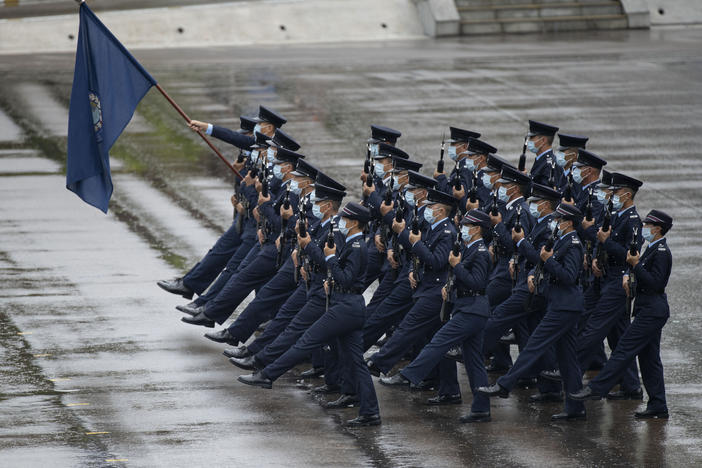 Hong Kong police show their new goose step marching style on National Security Education Day at a police school in Hong Kong on April 15.
