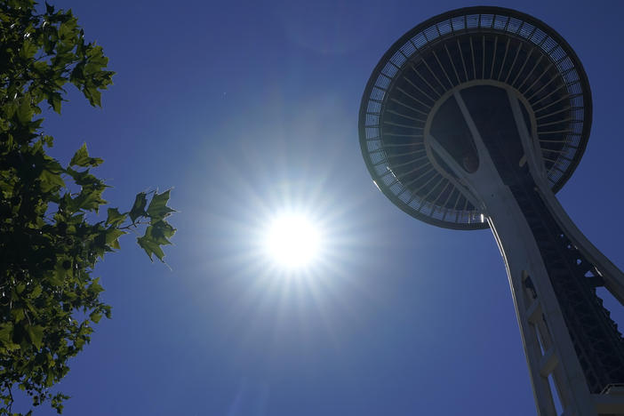 The sun shines near the Space Needle, Monday, June 28, 2021, in Seattle. Seattle and other cities broke all-time heat records over the weekend, with temperatures soaring well above 100 degrees.