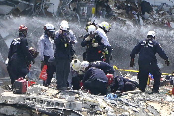 Rescue workers search the rubble of the Champlain Towers South condominium, Saturday. Search and rescue teams found another victim buried underneath the rubble on Tuesday, bringing the death toll to 12.