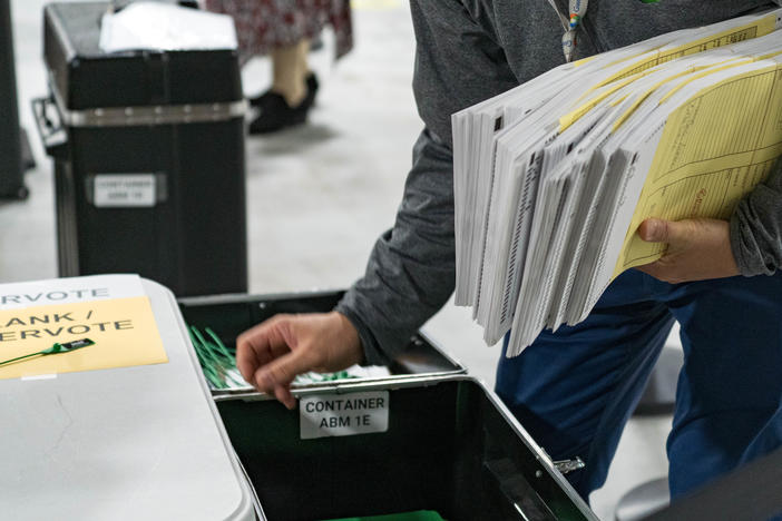 Georgia election workers begin their recount of ballots after the November election. Despite three recounts of the tally, former President Donald Trump and his allies falsely claim electoral fraud cost him the state.