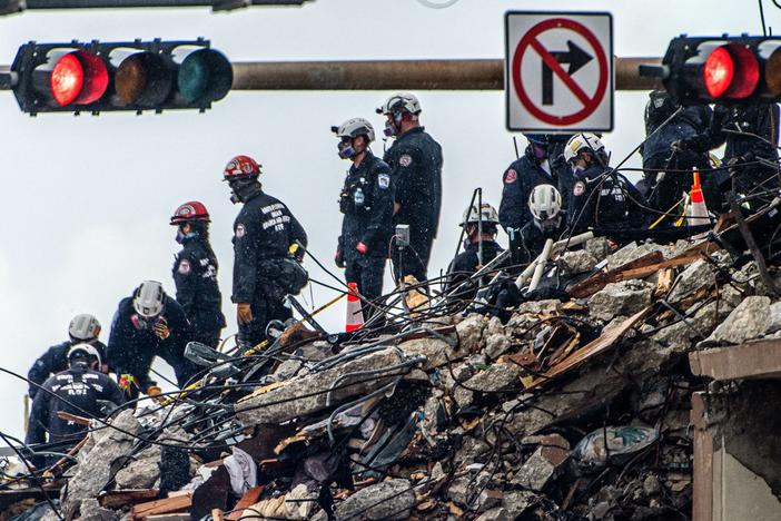 Search and rescue teams look for possible survivors in the partially collapsed 12-story Champlain Towers South condo building on Wednesday in Surfside, Fla.