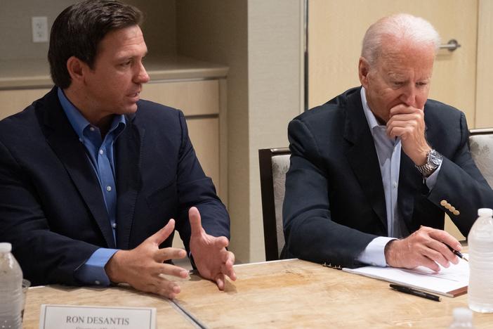 President Biden listens Thursday as Florida Gov. Ron DeSantis discusses the collapse of the 12-story Champlain Towers South condo building in Surfside, Fla.