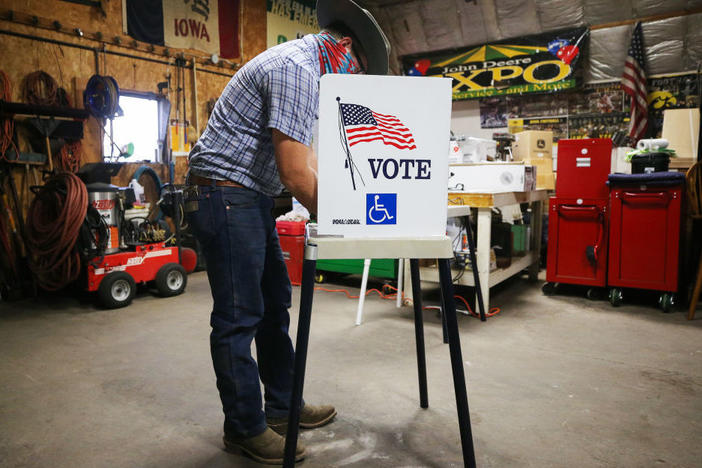 A voter marks his ballot at a polling place on Nov. 3 in Richland, Iowa. A new poll finds ensuring access to voting is more important than tamping down on voter fraud for most Americans.