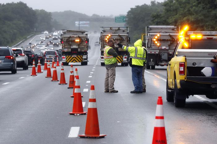 Traffic on Interstate 95 was diverted for hours after a group of armed men fled from police near Wakefield, Mass. on Saturday. Massachusetts state police say 11 suspects have been taken into custody.
