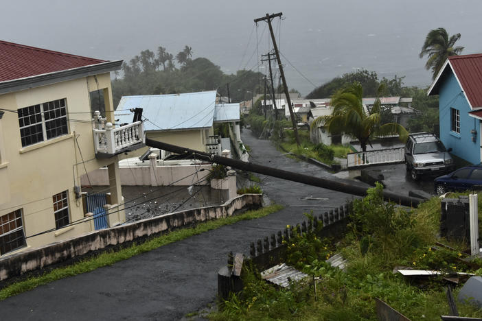 An electrical pole felled by Hurricane Elsa leans on the edge of a residential balcony, in Cedars, St. Vincent. Elsa strengthened into the first hurricane of the Atlantic season on Friday as it blew off roofs and snapped trees in the eastern Caribbean, where officials closed schools, businesses and airports.