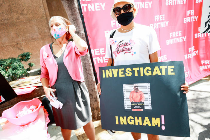 #FreeBritney activists protesting outside a Los Angeles courthouse, sporting a sign that reads "Investigate Ingham!"