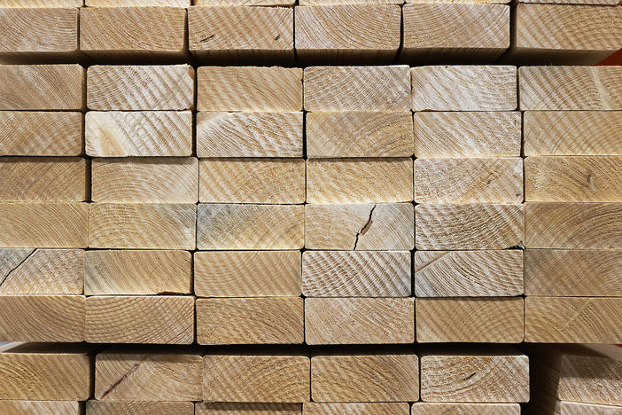 Lumber is stacked up for sale at a Home Depot store in May in Doral, Fla. Lumber prices surged during the pandemic, only to fall as the economy started to open up again. But prices remain volatile and still more expensive than pre-pandemic levels.