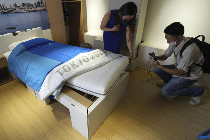 Journalists look at cardboard beds for the Tokyo 2020 Olympic and Paralympic at the Village Plaza near Tokyo 2020 Olympic and Paralympic Village Sunday, June 20, in Tokyo.