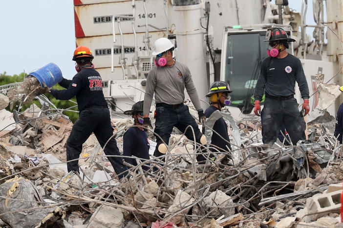 Search teams continue work Wednesday as efforts move into a recovery operation at the collapsed Champlain Towers South condo building in Surfside, Fla.