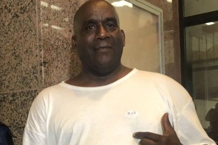 Hervis Rogers points to his "I voted" sticker on Super Tuesday in 2020. This week he was arrested for allegedly voting while on parole, which is illegal in Texas.