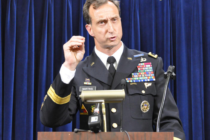 Army Brig. Gen. Mark Martins, Guantánamo's chief prosecutor, addresses the media on Oct. 19, 2012, at the end of a week of pretrial hearings for the five alleged architects of the 9/11 attacks. Martins announced his retirement this week.