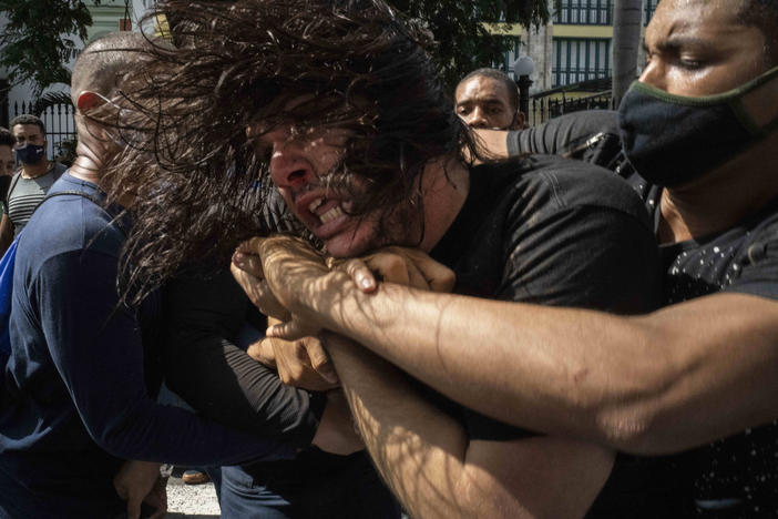 Plainclothes police detain an anti-government protester during a protest in Havana, Cuba, on Sunday. Hundreds of demonstrators went out to the streets in several cities in Cuba to protest against ongoing food shortages and high prices of foodstuffs.