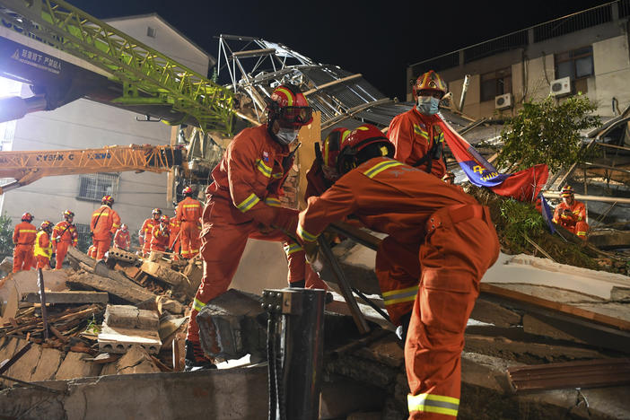 In this photo released by Xinhua News Agency, rescuers prepare equipment as they search for survivors at a collapsed hotel in Suzhou in eastern China's Jiangsu Province on Monday.