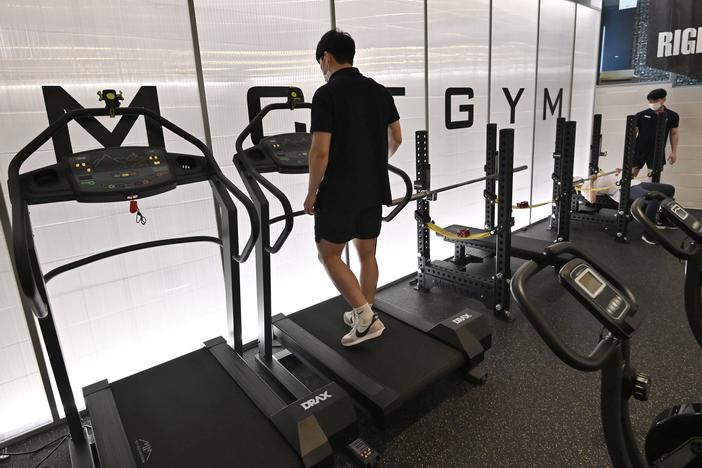 People exercise at a gym in Seoul on July 13, 2021 as South Korea announced implementation of level 4 social distancing measures amid concerns of a fourth wave of the coronavirus pandemic.