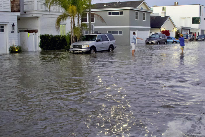 Streets and homes flooded in Newport Beach, Calif., during a high tide in July 2020. So-called sunny day floods are getting more common in coastal cities and towns as sea levels rise due to climate change.