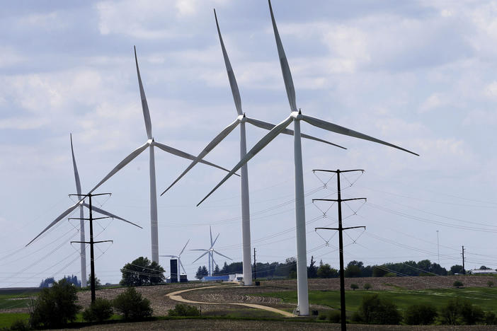 Wind turbines in a field in Adair, Iowa. Democrats' budget deal would use financial carrots and sticks to encourage utilities to shift to clean energy.