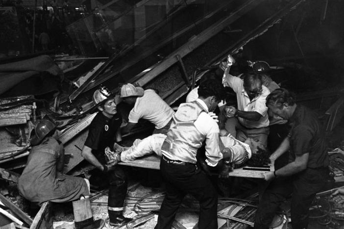 Firefighters rescue people from under a collapsed walkway in the lobby of the Hyatt Regency Hotel in Kansas City, Mo., on July 17, 1981. The collapse killed 114 people and injured more than 200.
