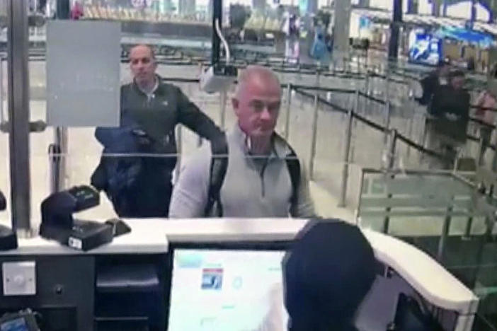 This Dec. 30, 2019, image from security camera video shows Michael L. Taylor, center, and George-Antoine Zayek at passport control at Istanbul Airport in Turkey. A Tokyo court handed down prison terms for the American father Michael Taylor and son Peter accused of helping Nissan's former chairman, Carlos Ghosn, escape to Lebanon while awaiting trial in Japan.
