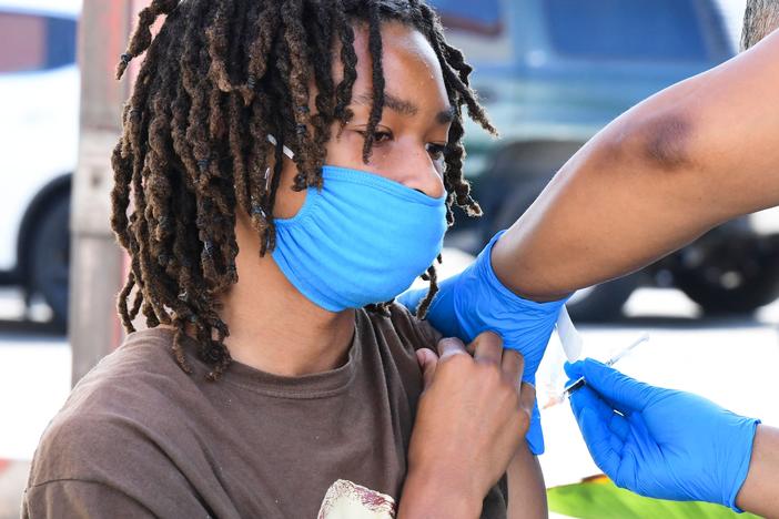 COVID-19 cases across the U.S. are rising in all 50 states as the delta variant of the coronavirus spreads. Here, a teenager receives a COVID-19 vaccine on July 16 at a mobile vaccine clinic hosted by Mothers in Action and operated by the Los Angeles County Department of Public Health.