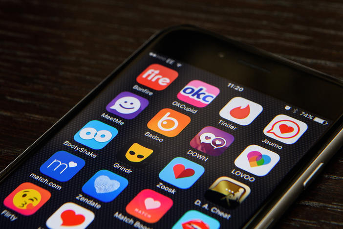A selection of online dating app logos are seen on a mobile phone screen. Google searches for "dating" have jumped to a 5-year high.