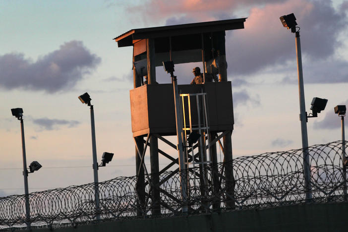 A U.S. military guard tower stands on the perimeter of the detainee camp on September 16, 2010, in Guantánamo Bay, Cuba. There are now 39 detainees remaining after the prisoner transfer on July 19, 2021.