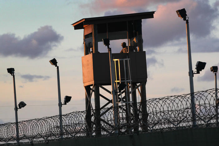 A U.S. military guard tower stands on the perimeter of the detainee camp on September 16, 2010, in Guantánamo Bay, Cuba. There are now 39 detainees remaining after the prisoner transfer on July 19, 2021.