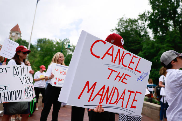 People gather last month on Indiana University's Bloomington campus to protest the college's vaccine requirement. A group of students sued the school, claiming the policy violated their rights.