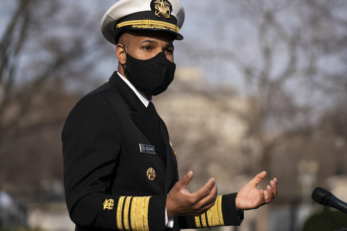 Dr. Jerome Adams, then the U.S. surgeon general, talks to reporters at the White House in December.