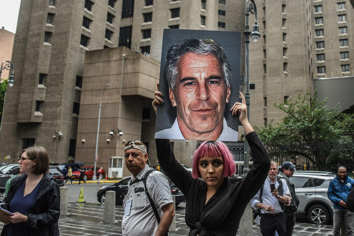 A member of the protest group Hot Mess holds up a sign of Jeffrey Epstein in front of the Metropolitan Correctional Center in New York City in July 2019. Epstein died by asphyxiation in his cell a month later.