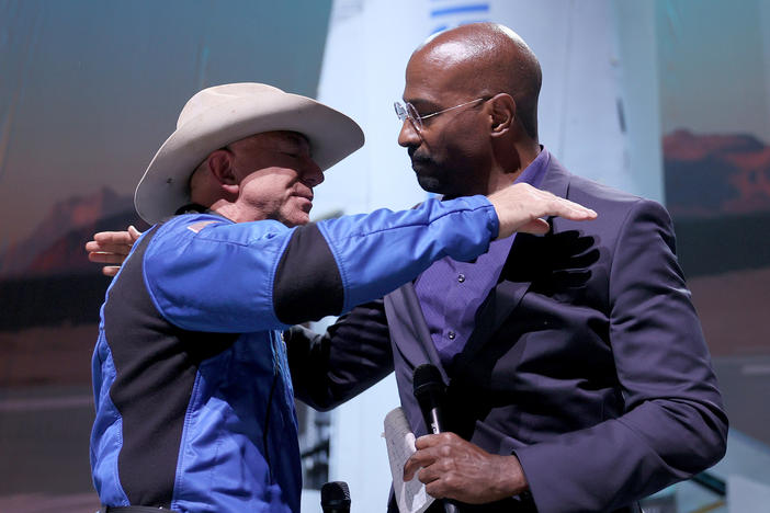 Jeff Bezos hugs Van Jones, founder of Dream Corps, on Tuesday after announcing a $200 million award to him and chef José Andrés for charities of their choice.