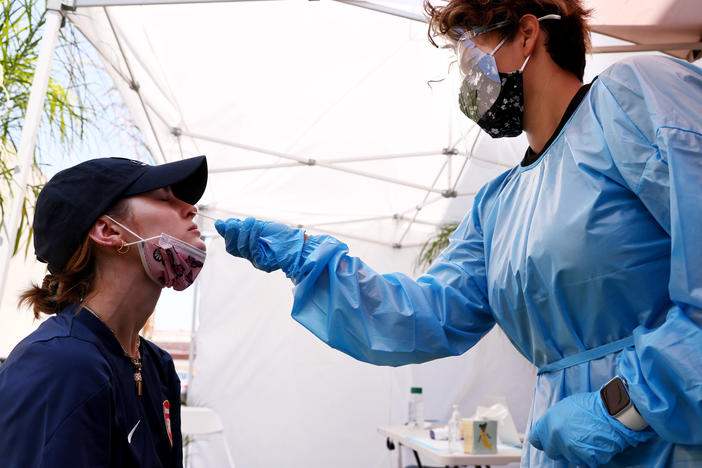 A medical assistant administers a coronavirus test last week in Los Angeles. COVID-19 cases are on the rise as the highly transmissible delta variant has become the dominant coronavirus strain in the United States.