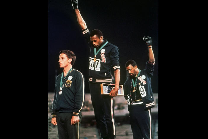 In a famous moment from the 1968 Summer Olympics in Mexico City, U.S. athletes Tommie Smith (center) and John Carlos raise their gloved fists after Smith received the gold medal and Carlos the bronze for the 200-meter run.