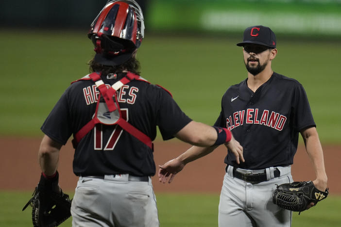 Cleveland relief pitcher Nick Sandlin (right) and catcher Austin Hedges celebrate a 10-1 victory over the St. Louis Cardinals on June 8. On Friday, the Cleveland team announced its new name, the Guardians.