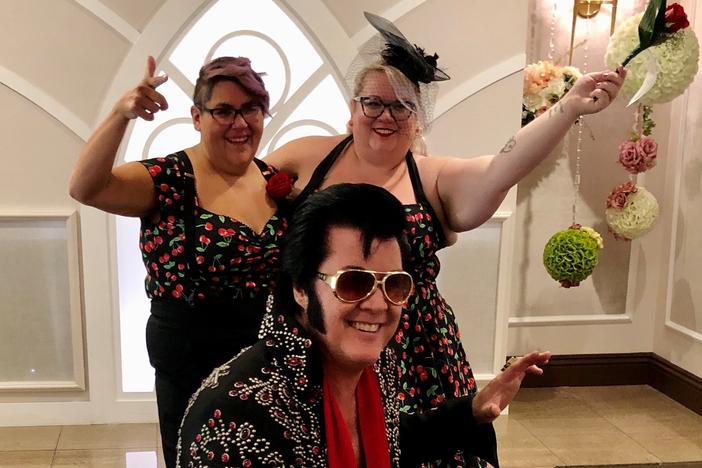 Brendan Paul (center) poses in front of newlyweds Jess Sandoval and Alana Stroebel at the Graceland wedding chapel in downtown Las Vegas.