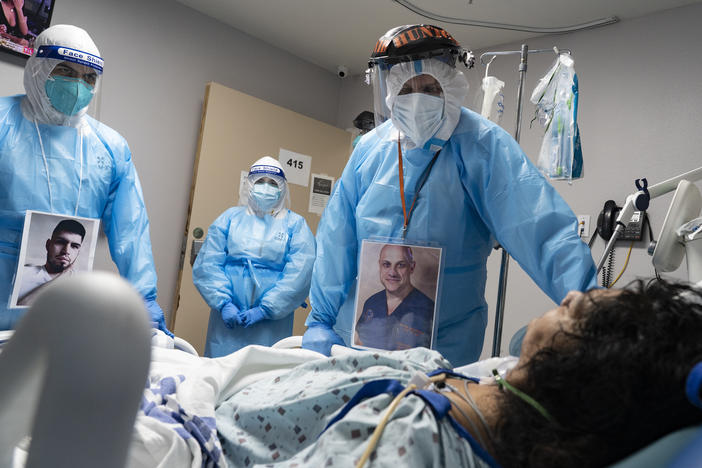 Medical staff members check on a patient in the COVID-19 Intensive Care Unit at United Memorial Medical Center in Houston last November. Doctors are now investigating whether people with lingering cognitive symptoms may be at risk for dementia.
