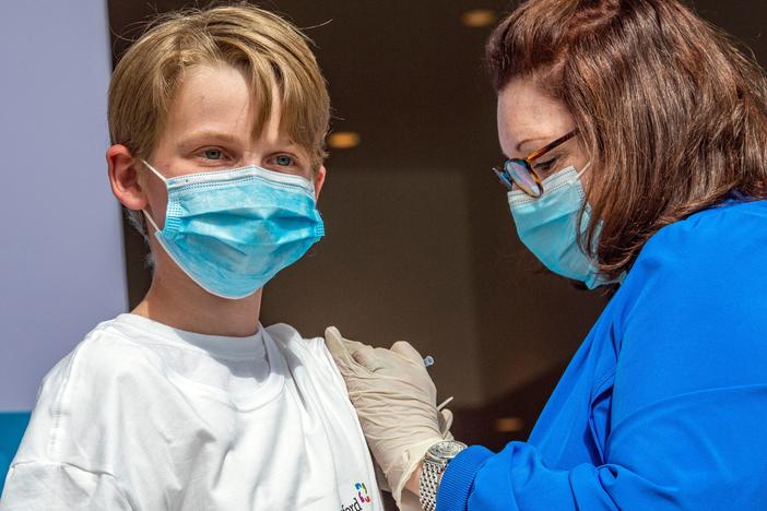 Charles Muro, 13, is inoculated at a mass vaccination center in Hartford, Conn., on May 13.