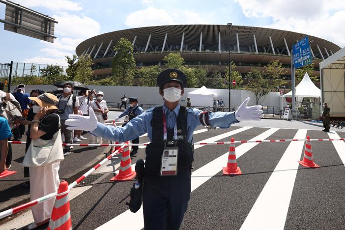 Police manage the crowd outside the Olympic Stadium in Tokyo on July 23, 2021, ahead of the opening ceremony of the 2020 Tokyo Olympic Games.