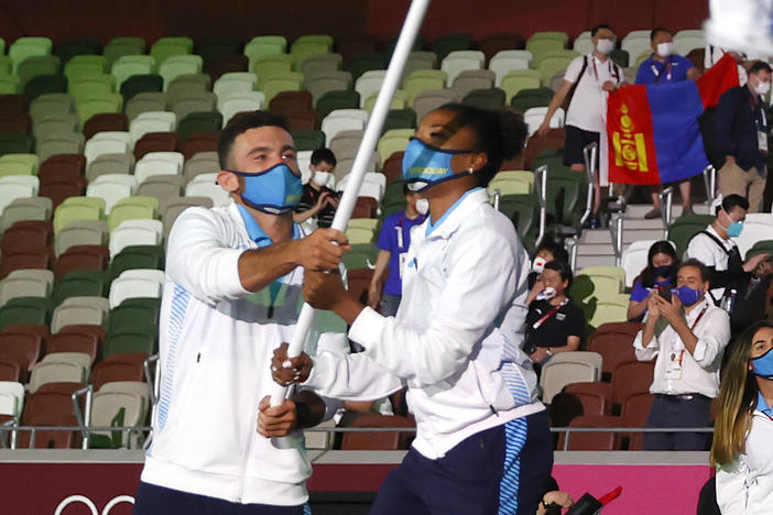 Uruguay flag bearers Deborah Rodriguez and Bruno Cetraro Berriolo lead their team out during the opening ceremony of the Tokyo 2020 Olympic Games at Olympic Stadium.