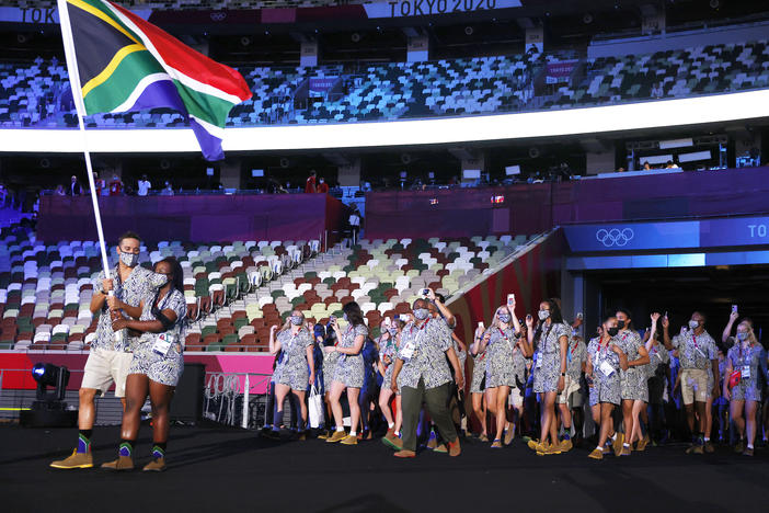 Flag bearers Phumelela Luphumlo Mbande and Chad Le Clos of Team South Africa lead their team out during the opening ceremony of the Tokyo Olympic Games on Friday.