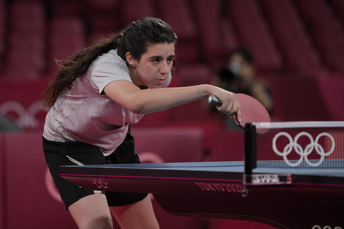 Syria's Hend Zaza competes during a women's table tennis singles preliminary round match against Austria's Liu Jia at the Summer Olympics in Tokyo.