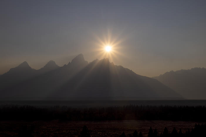 A peak is shrouded in smoke from regional wildfires on July 14, at Grand Teton National Park, south of Yellowstone.