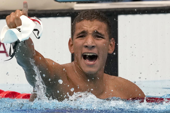 Tunisia's Ahmed Hafnaoui celebrates after his unexpected victory in the final of the men's 400-meter freestyle at the 2020 Summer Olympics in Tokyo.