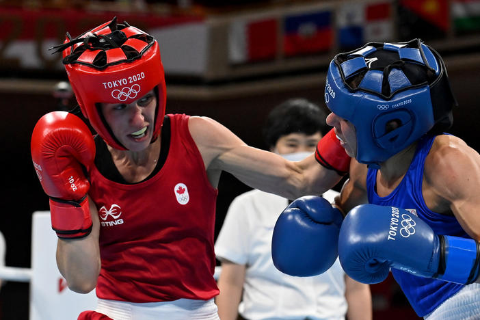 Mandy Bujold (L) of Canada exchanges punches with Nina Radovanovic of Serbia during the Women's Fly on Sunday at the Tokyo Olympics.