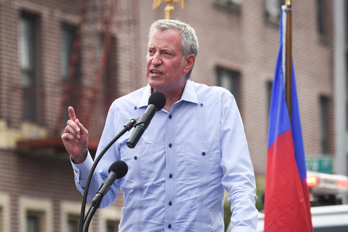 New York City Mayor Bill de Blasio said Monday that city workers will be required to be vaccinated or get tested weekly for COVID-19. De Blasio is seen here in Brooklyn on Sunday at a rally in support of Haiti.