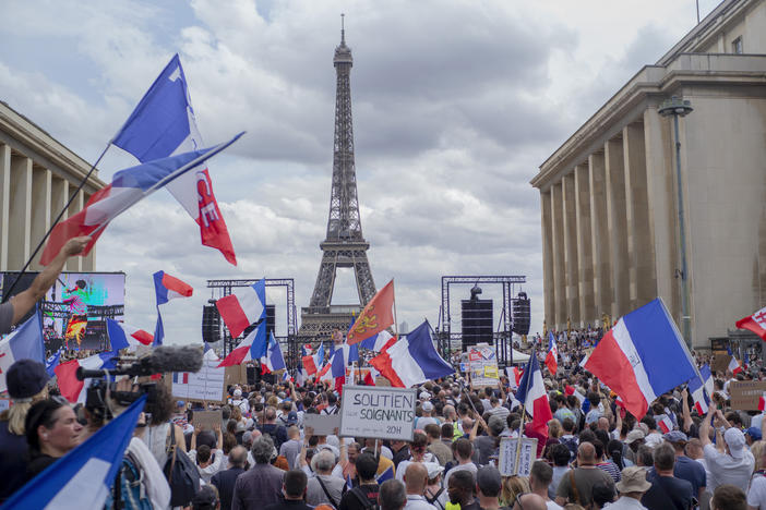 Thousands of protesters gather near the Eiffel Tower to protest the COVID-19 pass which grants vaccinated individuals greater ease of access to venues.