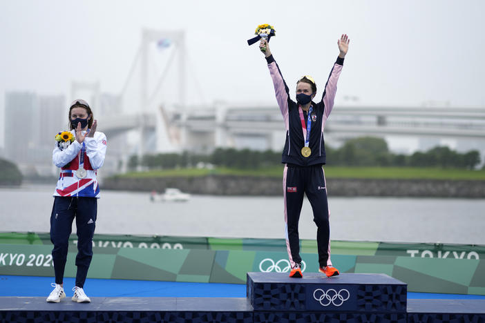 Gold medal winner Flora Duffy of Bermuda (center) celebrates her win in the triathlon on Tuesday, next to silver medalist Georgia Taylor-Brown of Great Britain.