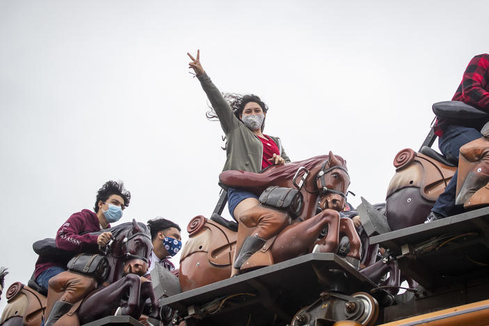 To mask or not to mask: That is the question for vaccinated people as the delta variant surges. The answer may depend on the situation, experts say. Here, these roller-coaster riders mask up at Knott's Berry Farm in Buena Park, Calif.