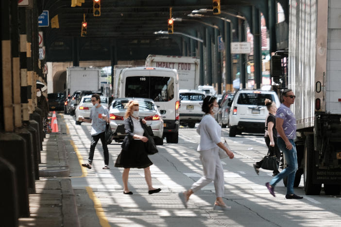 People walk along a main street in Brighton Beach, Brooklyn on Thursday in New York City.