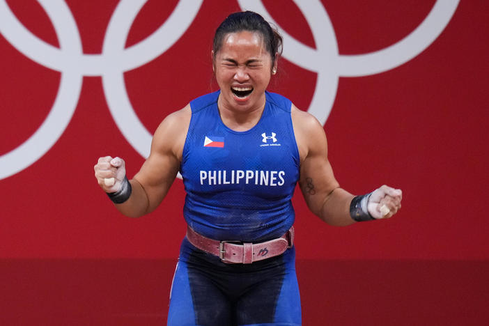 Hidilyn Diaz of the Philippines celebrates winning the women's 55-kilogram weightlifting match at the Tokyo 2020 Games — her country's first Olympic gold medal.